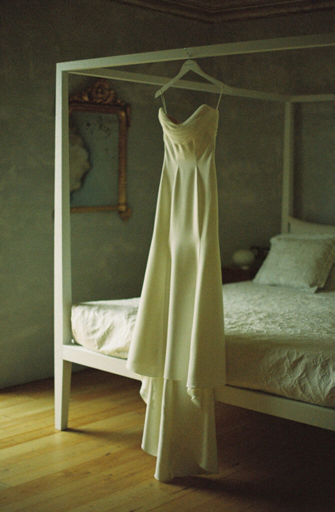 ​Weddings in Sicily, Italy provide the perfect spaces to capture wedding details like this wedding dress hanging from the best post. 