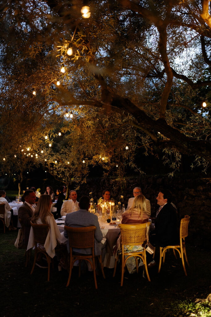 Monaci delle Terre Nere wedding reception under string lights in the olive groves. 